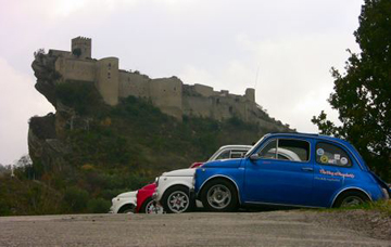 Fiat 500 cars in front of castle in Abruzzo Italy
