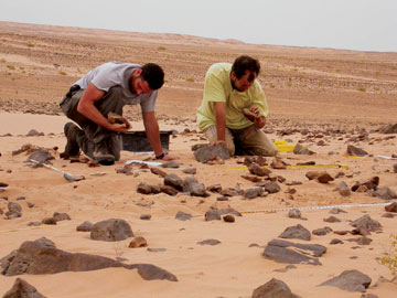 Jeffrey Rose and a colleague look for stone tools