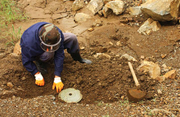 A worker prepares to destroy landmines