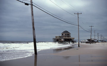 Beach washing away beneath a house