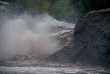 Temporary earthen dam washing away