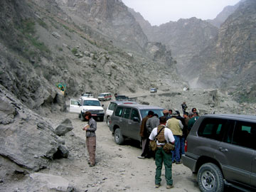 Geologists inspect an outcrop along a highway