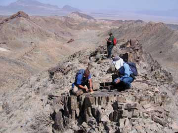Picture of people examining rocks in the Saghand area in Iran
